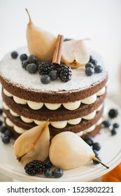 Sweet Table. Halloween Wedding Luxor Decor. Chocolate Cake With Blackberries, Blueberries, Pears And Cinnamon Sticks. 