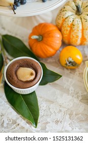 Sweet Table. Halloween Wedding Luxor Decor. Chocolate Cake, Pears. Surrounded By Orange Pumpkins