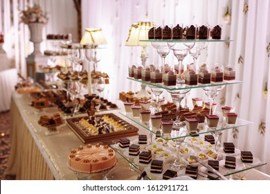 Sweet Table For Wedding. Candy Bar With A Lot Of Different Candies And Sweet Chokolate Cakes