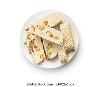 Sweet tahini halva with almonds. Turkish dessert isolated on a white background.