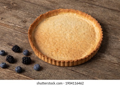 Sweet Tart Crust Decorated With Fresh Berries On Wooden Table 