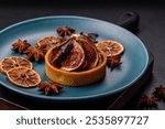 Sweet tart with figs, cheese cream and pecans on a dark concrete background