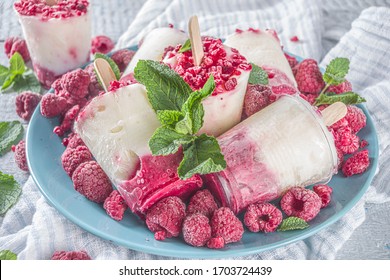 Sweet And Tasty Diet Summer Dessert. Homemade Raspberry Yogurt Popsicle With Fresh Raspberries And Mint. Healthy Ice Cream Recipe. Wooden White Background Copy Space