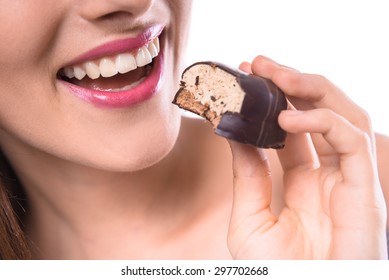 Sweet Temptation. Beautiful Woman Tasting  Chocolate Biscuit Over White Background. Close-up.