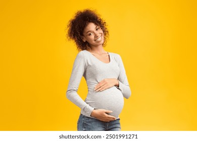 Sweet time of pregnancy. Happy expectant woman hugging her belly over pink studio background - Powered by Shutterstock