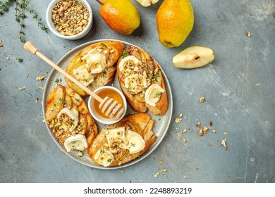 Sweet toast with pear, cheese and honey. party appetizer. banner, menu, recipe place for text, top view. - Powered by Shutterstock