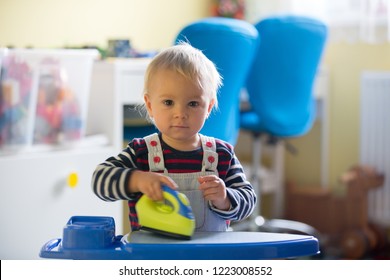 Sweet Toddler Boy, Playing With Toy Iron And Iron Board, Helping Mom With The Laundry