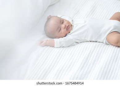 Sweet Two Month Old Newborn Baby Boy Sleep On White Sheet Bed,asian Little Baby Napping In Bed At Home.