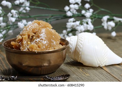 Sweet Whole Wheat Halwa Or Porridge On A Dark Background With Grated Coconut With Copy Space , Selective Focus.