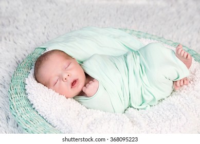 Sweet Wrapped In A Nappy Newborn Baby Sleeping On A Soft Blanket