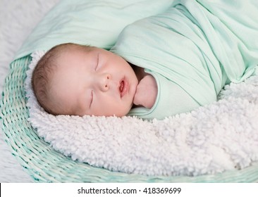 Sweet Wrapped In A Nappy Newborn Baby Sleeping On A Soft Blanket