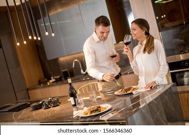 Sweet young couple having a romantic dinner at luxury kitchen