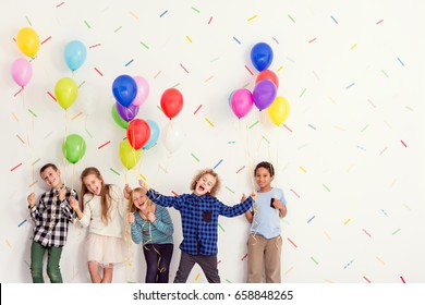 Sweet Young Happy Kids Standing With Balloons