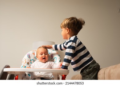 Sweet younger brother is taking care of his little baby sister - Shutterstock ID 2144478053