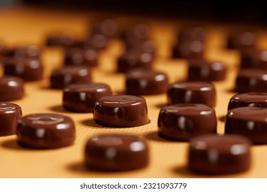Sweets candy on chocolate factory conveyor. Process cocoa glazing marzipan.