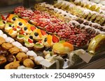 Sweets of Catania, Sicily. Italian pastries: profiteroles, fruit tartelettes and cannoli.