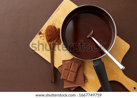 Similar – Image, Stock Photo Chocolate bar on cocoa powder pile. Chocolate and ingredients