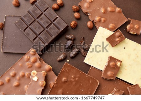 Similar – Image, Stock Photo Chocolate bar on cocoa powder pile. Chocolate and ingredients