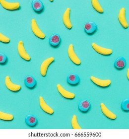 Sweets In The Form Of Bananas And Marmalade Candy Or Gum On A Blue Background