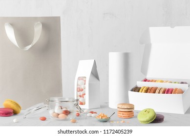 Sweets, packaging composition mockup on white wooden background, with cookies, candies and blank copy space to place your logo