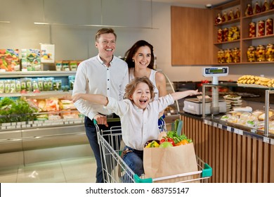 Swift Healthy Happy Family Dad Mom And Son With Arms Outstretched Sitting In A Grocery Cart Choose Wholesome Organic Food During Shopping