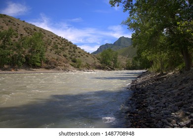 A Swift River Flows On Rocky Shores Through A Valley At The Foot Of The Mountains. Altai, Siberia, Russia.