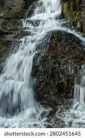A swift stream flows over the rocks, Silky water in a long exposure shot