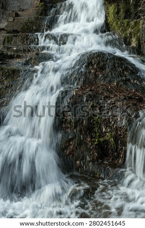 A swift stream flows over the rocks, Silky water in a long exposure shot