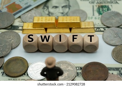 SWIFT.Society Worldwide Interbank Financial Telecommunication.concept of international finance, commerce and banking.table covered with banknotes and gold, dice with the word.