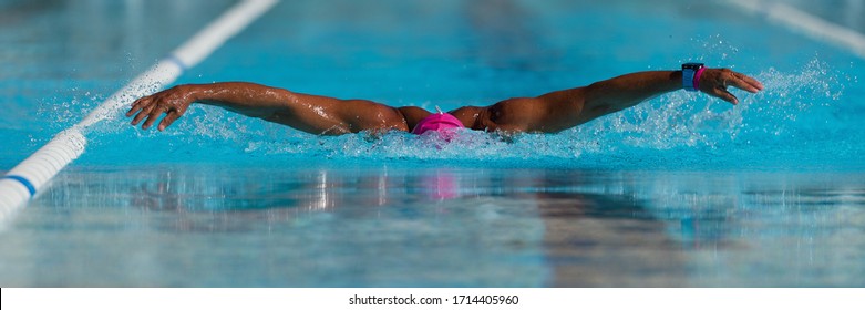 Swim competition swimmer athlete doing butterfly stroke in swimming pool