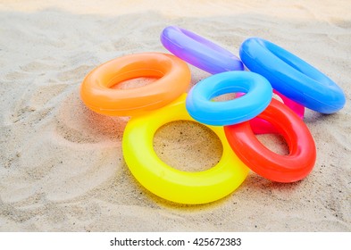 Swim Ring , Pool Ring Isolated On Beach Background