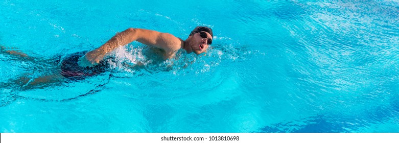 Swim sport athlete swimmer swimming in pool training for race. Professional male watersport adult working out cardio in water at outdoor fitness stadium. Banner panoramic crop. - Powered by Shutterstock