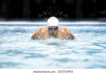 Swimmer in cap and glasses in swimming pool
