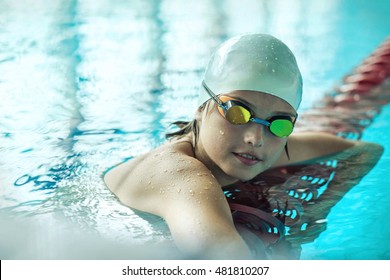 Swimmer Child. Portrait Of Swimming Child Athlete With Goggles After Training In Waterpool.