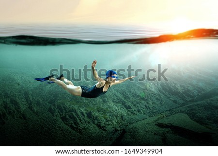 Similar – From below full body of unrecognizable active teen boy wearing yellow flippers snorkeling by coral reef in deep ocean with crystal clear waters at Menorca