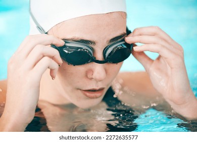 Swimmer, hands and face with goggles in fitness sports for exercise, workout or training in swimming pool. Sporty athletic woman professional in practice for underwater swim competition in swimwear - Powered by Shutterstock