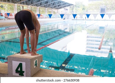 Swimmer On Starting Block For Jump To Swim And Train.