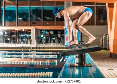 Swimmer Standing On Diving Board Ready To Jump Into Competition Swimming Pool 