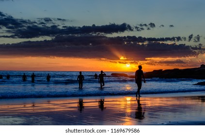 Swimmers Emerging From The Water At Sunrise At Manly Beach