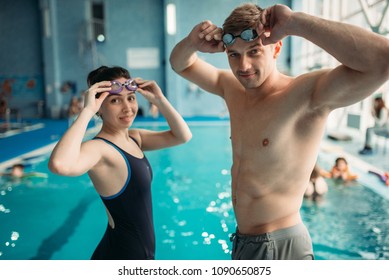 Swimmers Puts On A Goggles In Swimming Pool