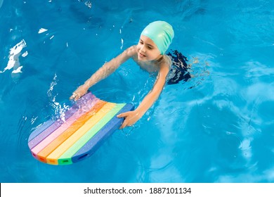 Swimming Class. Close Up Of Kids Practicing Flutter Kick With Kick Board In Swimming Pool