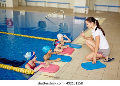 Swimming class listening to the coach - Powered by Shutterstock