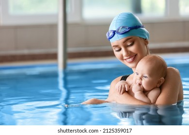 Swimming coach with adorable baby in pool - Powered by Shutterstock