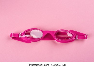 Swimming Goggles On Pink Background, Top View