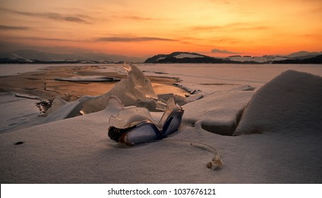 Swimming Googles And Colorful Sunset Over Frozen Lake Liptovska Mara, Slovakia