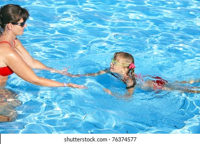 Swimming Instructor Learn Little Girl Swim.