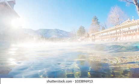 Swimming In Outdoor Hot Springs Pool In The Winter.