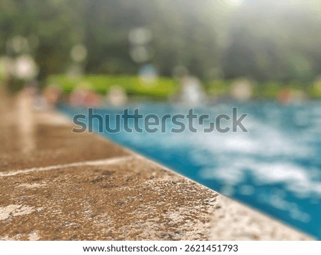 Swimming pool background. Edge of swimming pool. Selective focus on pool side