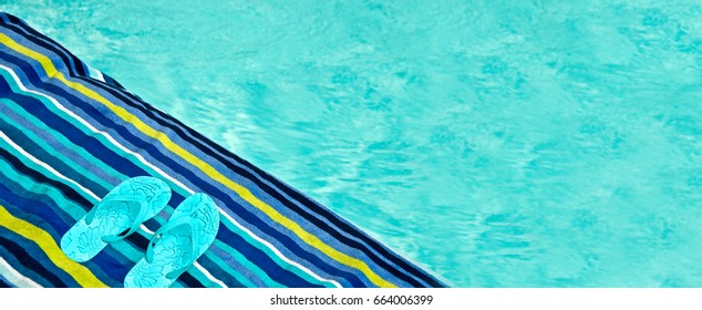 Swimming pool, bath towel and flip flops, panoramic background, summer concept
