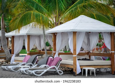 Swimming Pool Beds And Cabana Under Coconut Trees